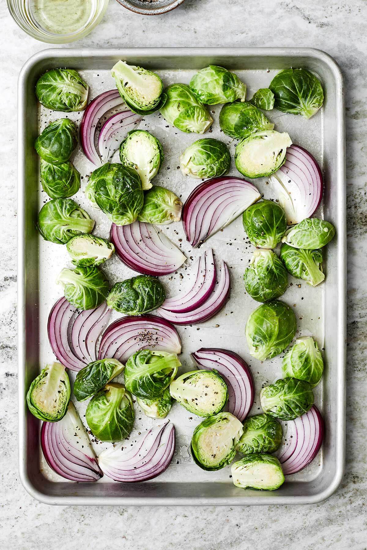 Roasting veggies on a sheet pan for balsamic chicken
