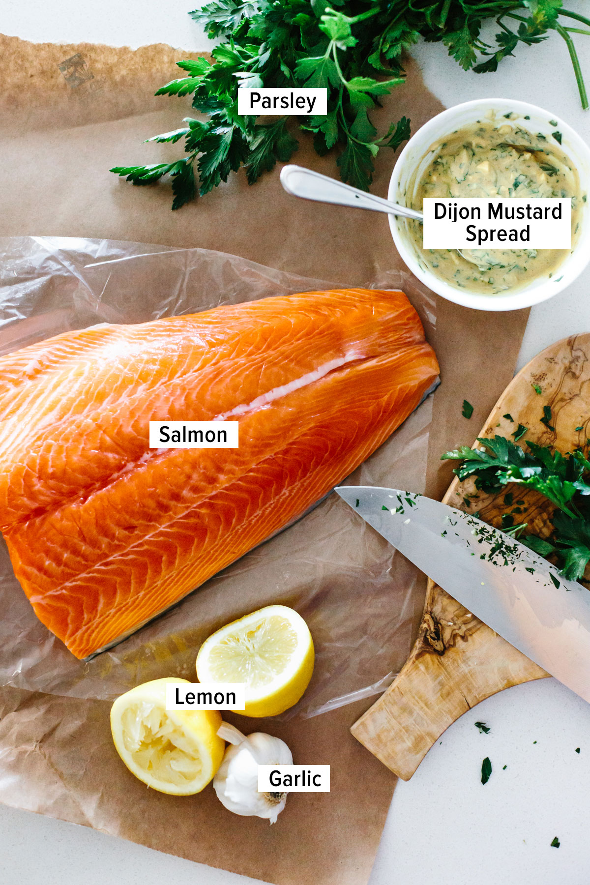 Ingredients to make Dijon baked salmon on a table.