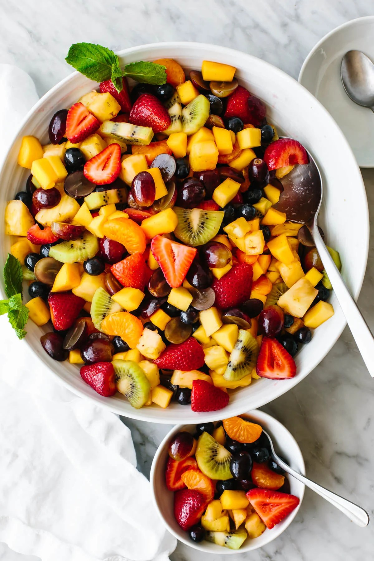 A large white bowl of classic fruit salad.