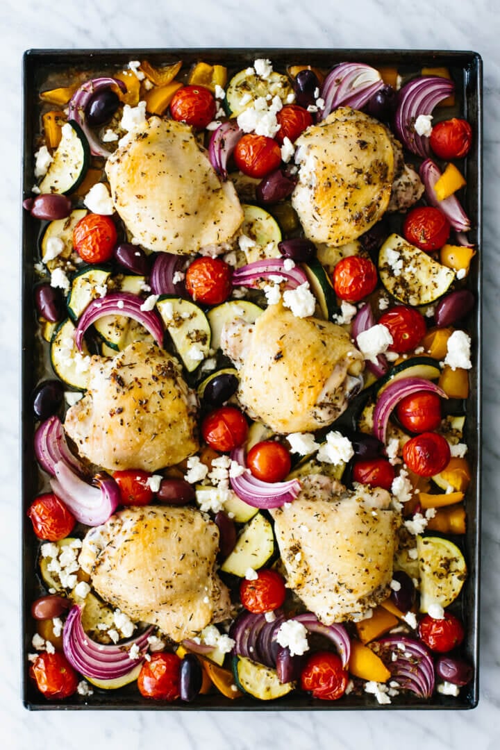A baking sheet with Greek chicken and vegetables
