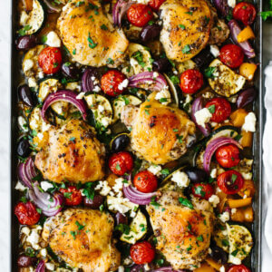 A sheet pan with Greek chicken and vegetables