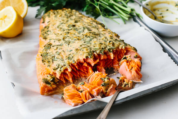 Whole fillet of dijon baked salmon with a fork.
