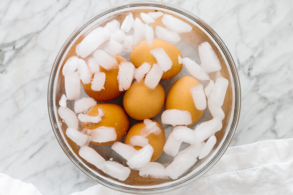 Cooling the hard boiled eggs in an ice water bath.